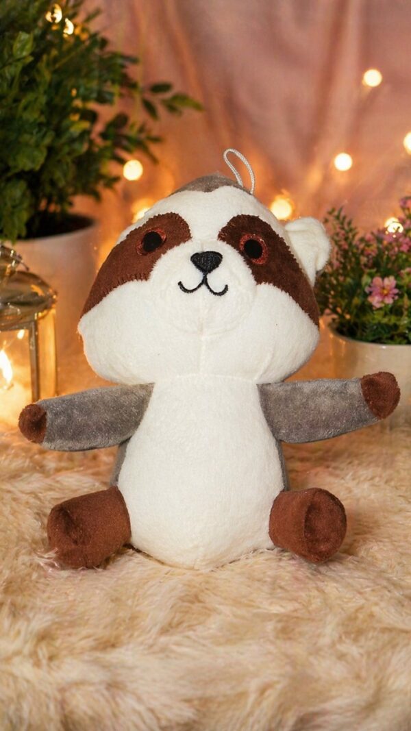 A cute grey raccoon plush toy holding a tiny nut, soft and huggable stuffed animal